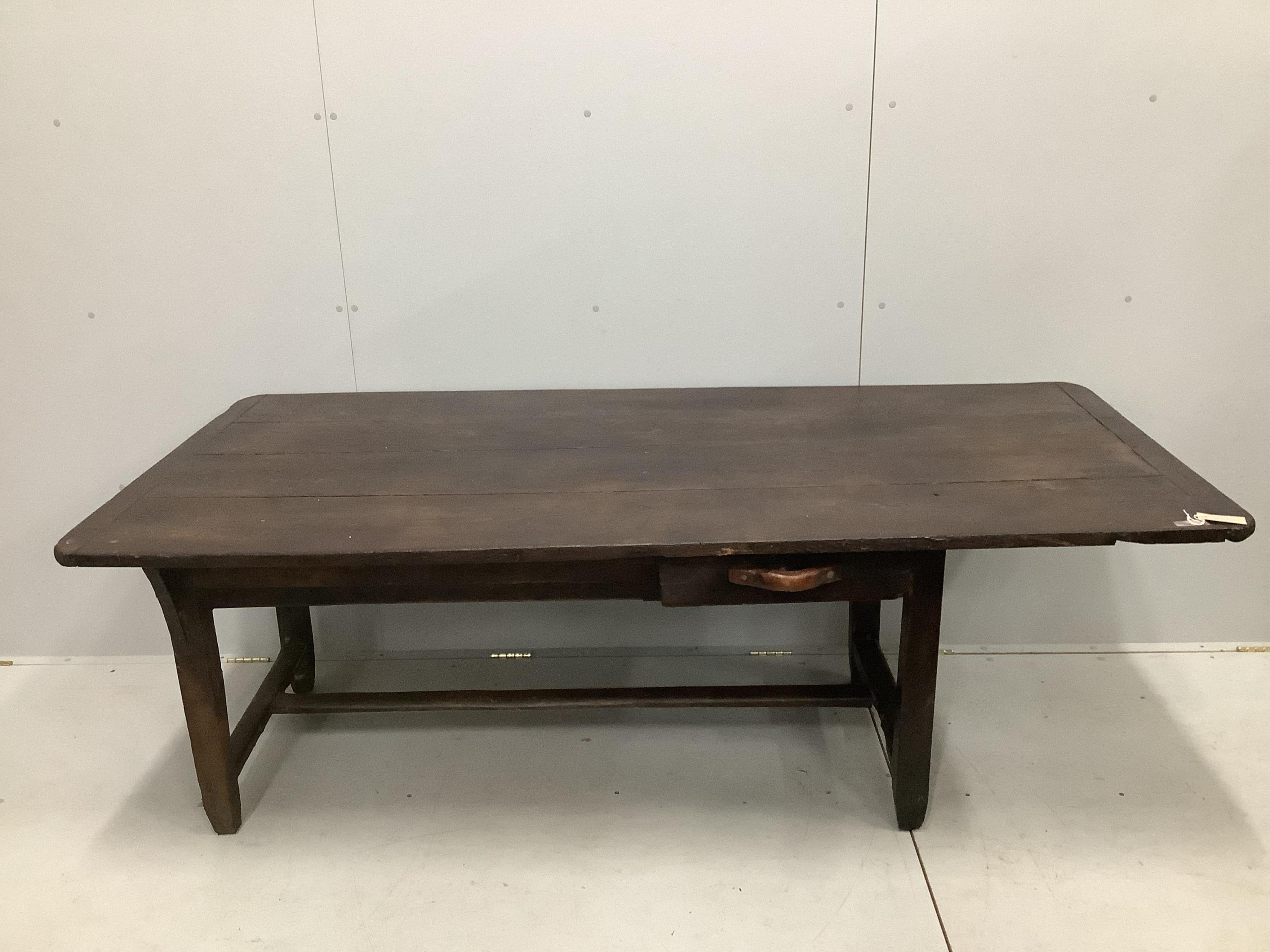 A 19th century French oak plank top kitchen table, width 198cm, depth 92cm, height 71cm, together with a pair of 19th century French oak benches, length 200cm, depth 24cm, height 42cm. Condition - fair